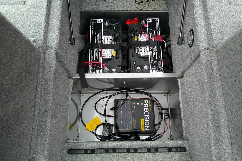 Slide: The Image of 2016 Lund 1775 Impact Sport boat battery compartment with charger and wiring. - 17