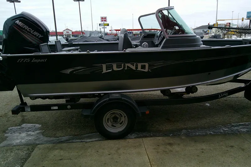Slide: The Image of 2016 Lund 1775 Impact Sport boat on trailer, parked outdoors. - 4