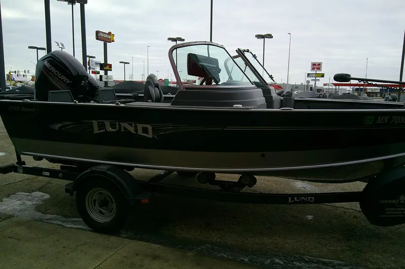 Slide: The Image of 2016 Lund 1775 Impact Sport boat on trailer in parking lot. - 5