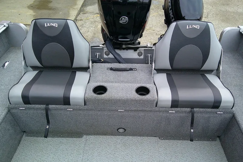 Slide: The Image of 2016 Lund 1775 Impact Sport boat seats with cup holders and motor in background. - 8