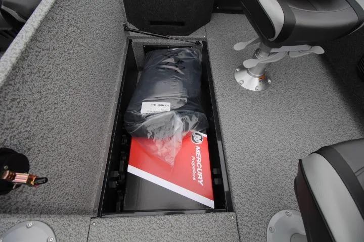 Slide: The Image of 2026 Lund 2075 Fisherman boat storage compartment with Mercury accessories and seating. - 10
