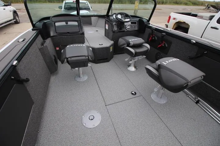 Slide: The Image of 2026 Lund 2075 Fisherman boat interior with seating and steering console. - 14