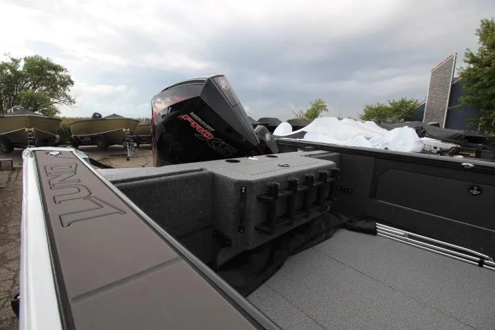 Slide: The Image of 2026 Lund 2075 Fisherman boat with powerful outboard motor, spacious deck, and rod holders. - 3