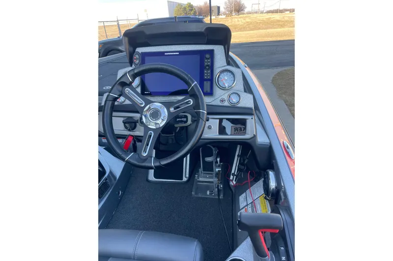 Slide: The Image of 2021 Nitro Z21 Pro boat dashboard with steering wheel and electronic display. - 2