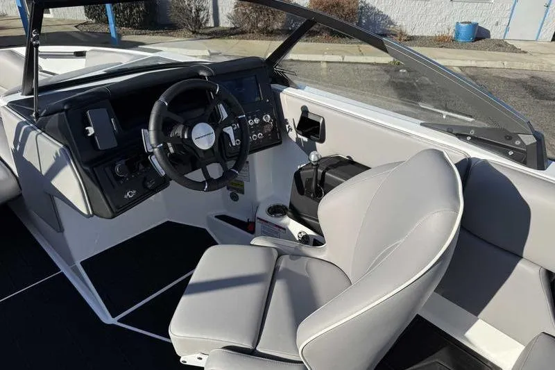 Slide: The Image of 2026 Moomba Craz boat interior with steering wheel and modern dashboard controls. - 10