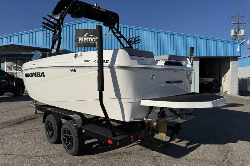 Slide: The Image of 2026 Moomba Craz boat on trailer outside Prestige Water Sports building. - 5