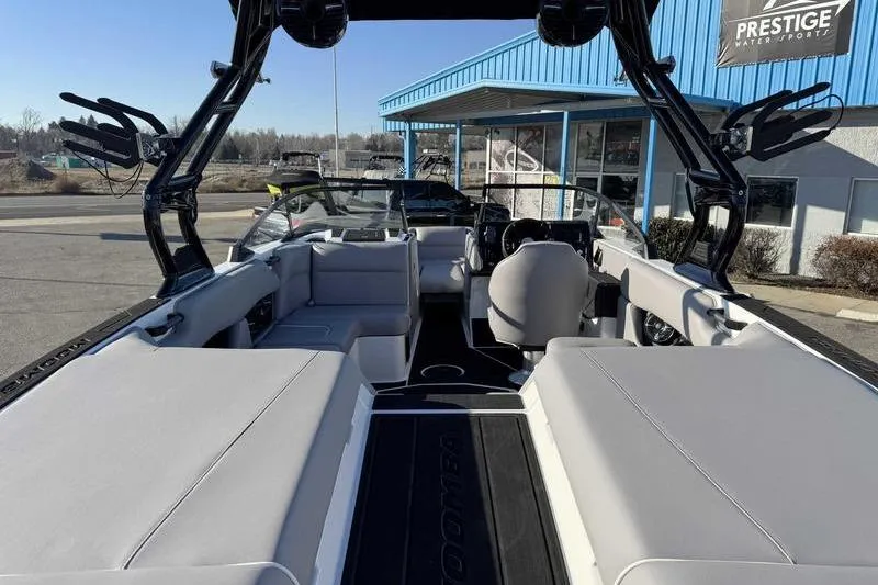 Slide: The Image of 2026 Moomba Craz boat interior with sleek seating and modern design at dealership. - 7