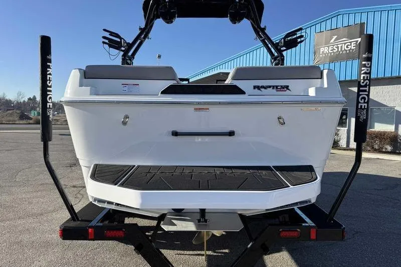 Slide: The Image of 2026 Moomba Craz boat rear view at Prestige dealership, showcasing Raptor engine. - 8