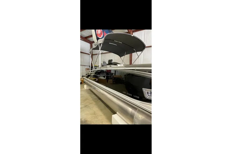 The Image of 2022 Avalon LSZ 2485 VRB pontoon boat in indoor storage facility. - 0