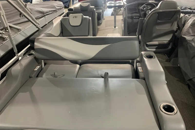 Slide: The Image of 2022 Avalon LSZ 2485 VRB boat interior with gray seating and cup holders. - 12