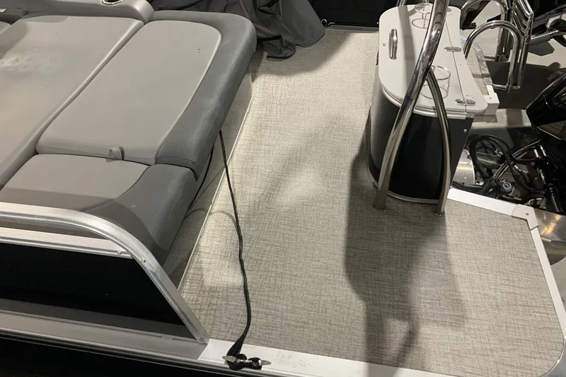 Slide: The Image of 2022 Avalon LSZ 2485 VRB boat interior with gray seating and carpeted floor. - 14
