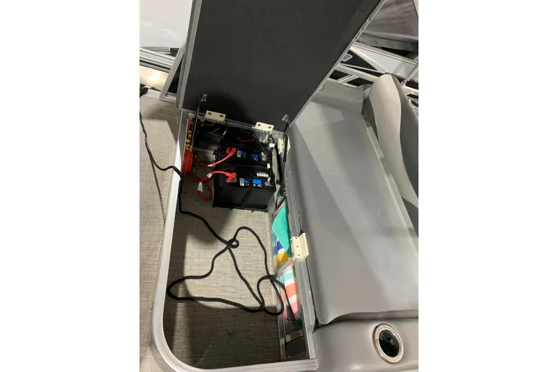 Slide: The Image of 2022 Avalon LSZ 2485 VRB boat battery compartment with wiring and storage. - 15