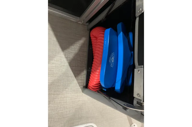 Slide: The Image of 2022 Avalon LSZ 2485 VRB storage compartment with blue and red boating accessories. - 20