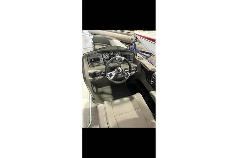 Slide: The Image of 2022 Avalon LSZ 2485 VRB boat interior with steering wheel and dashboard controls. - 23