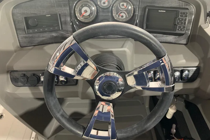 Slide: The Image of Steering wheel and dashboard of 2022 Avalon LSZ 2485 VRB boat with gauges and controls. - 8