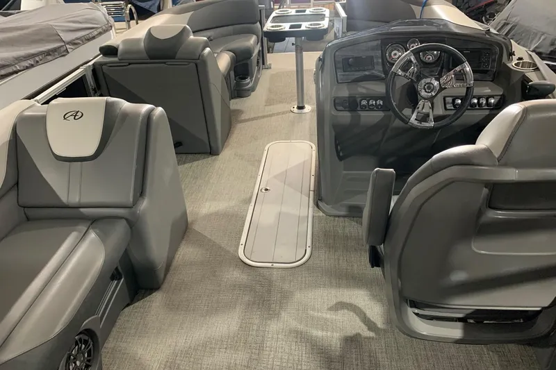 Slide: The Image of 2022 Avalon LSZ 2485 VRB boat interior with modern seating and steering console. - 9