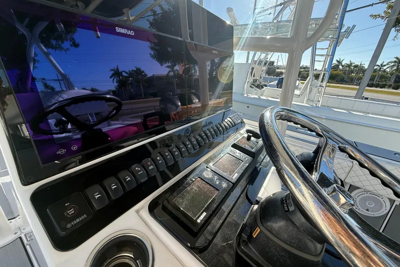 Slide: The Image of 2006 Contender 33 Tournament boat dashboard with steering wheel and Simrad display. - 14
