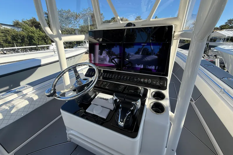 Slide: The Image of 2006 Contender 33 Tournament boat helm with steering wheel and navigation controls. - 20