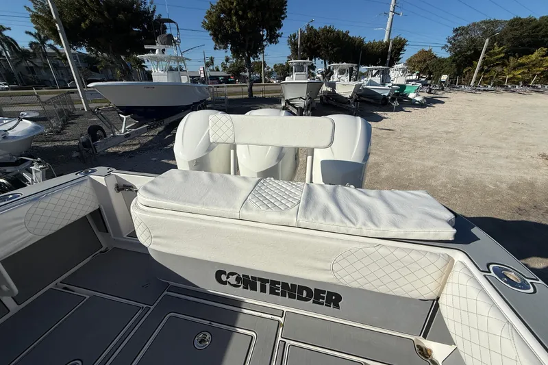 Slide: The Image of 2006 Contender 33 Tournament boat interior with cushioned seating and storage. - 9