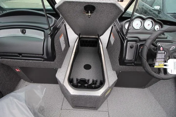 Slide: The Image of 2026 Lund 1875 Fisherman boat interior with open storage compartment and dashboard view. - 12