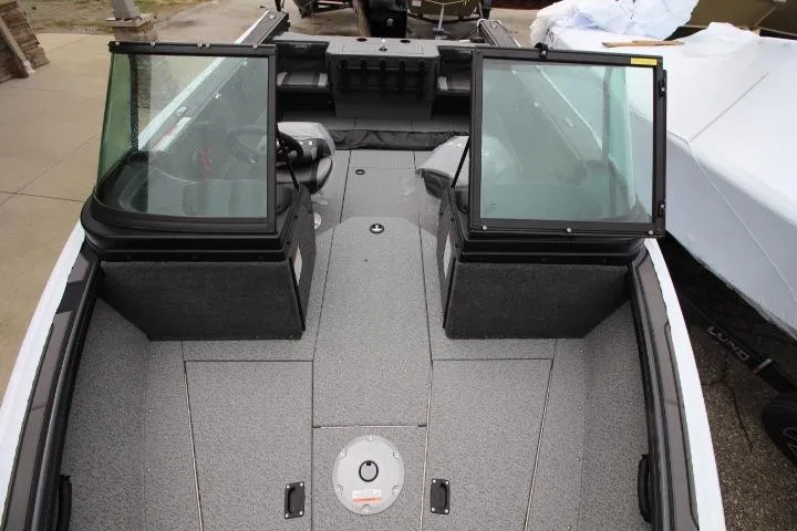 Slide: The Image of 2026 Lund 1875 Fisherman boat interior with dual windshields and spacious deck layout. - 7