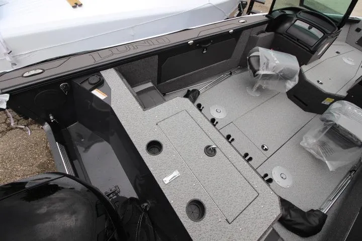 Slide: The Image of 2026 Lund 1875 Fisherman boat interior with seating and storage compartments. - 9