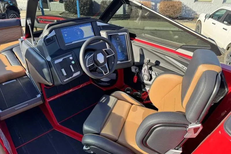 Slide: The Image of 2025 Supra SE boat interior with modern dashboard and tan leather seating. - 11