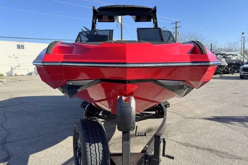 Slide: The Image of Red 2025 Supra SE boat on trailer, front view in outdoor setting. - 6
