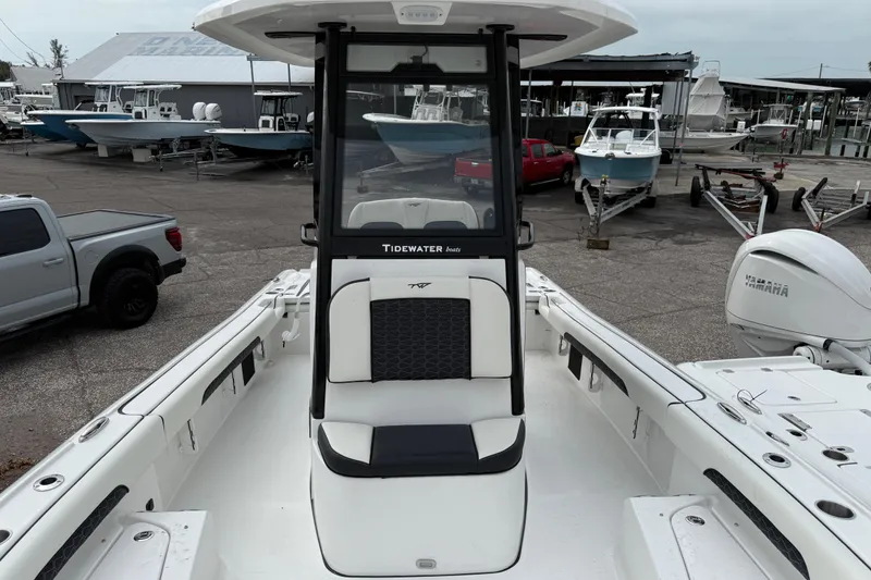Slide: The Image of 2026 Tidewater 2500 Carolina Bay boat at marina, featuring Yamaha engine and sleek design. - 2
