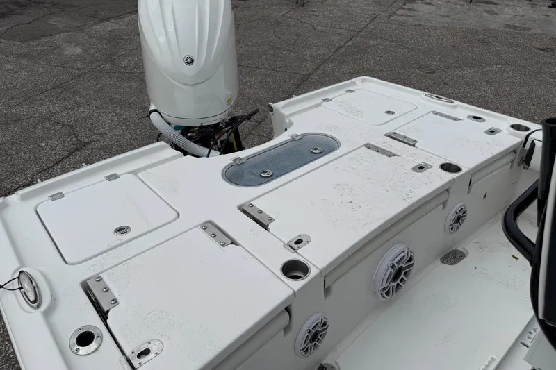 Slide: The Image of 2026 Tidewater 2500 Carolina Bay boat deck with storage compartments and motor. - 4