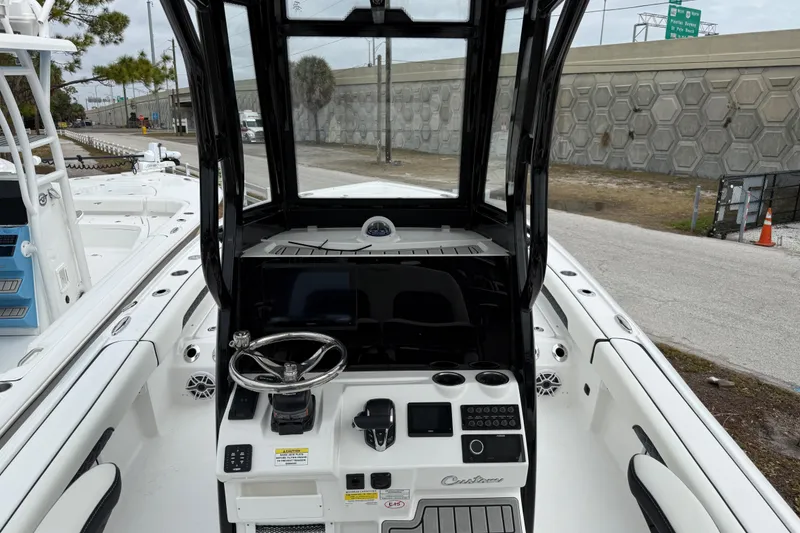 Slide: The Image of 2026 Tidewater 2500 Carolina Bay boat interior with steering console and modern controls. - 6