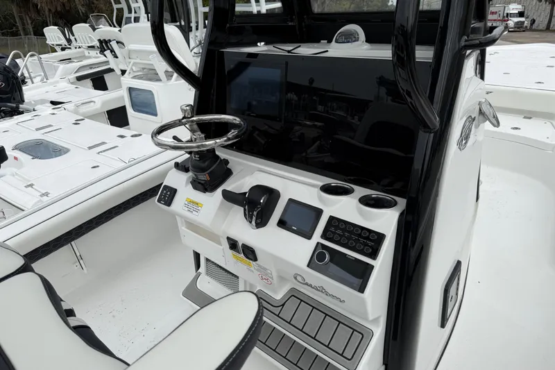 Slide: The Image of 2026 Tidewater 2500 Carolina Bay boat console with steering wheel and control panel. - 8