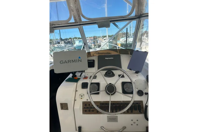 Slide: The Image of 2002 Mainship Pilot 34 helm with Garmin and Raymarine navigation systems. - 11