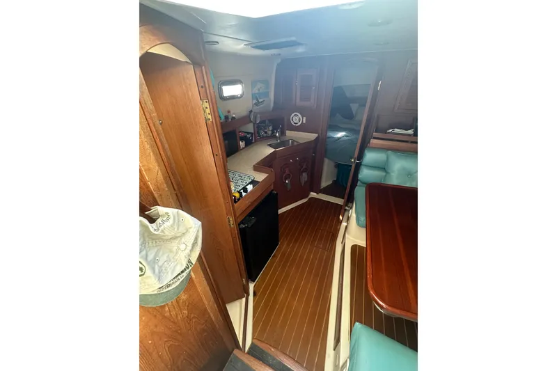 Slide: The Image of Interior of 2002 Mainship Pilot 34 boat with wood finish and seating area. - 14