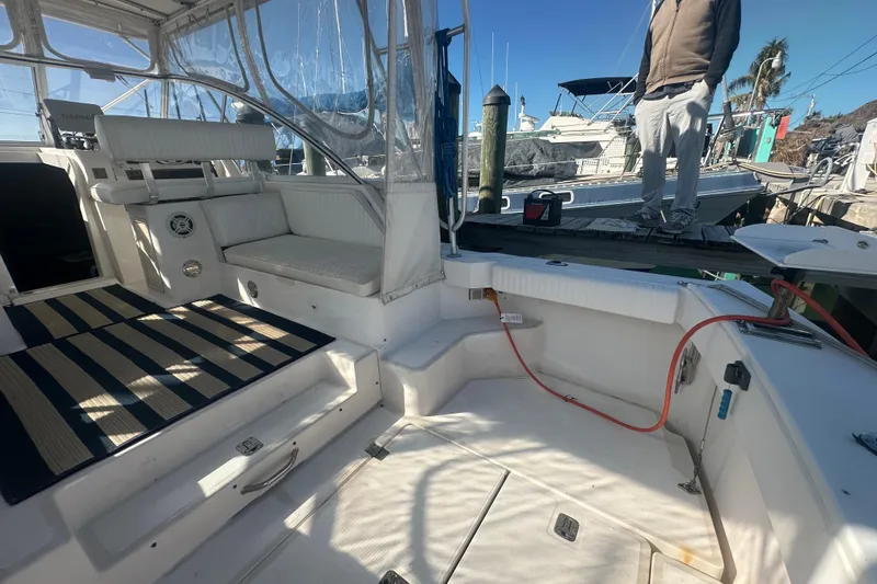 Slide: The Image of 2002 Mainship Pilot 34 boat interior with seating and dock view. - 19