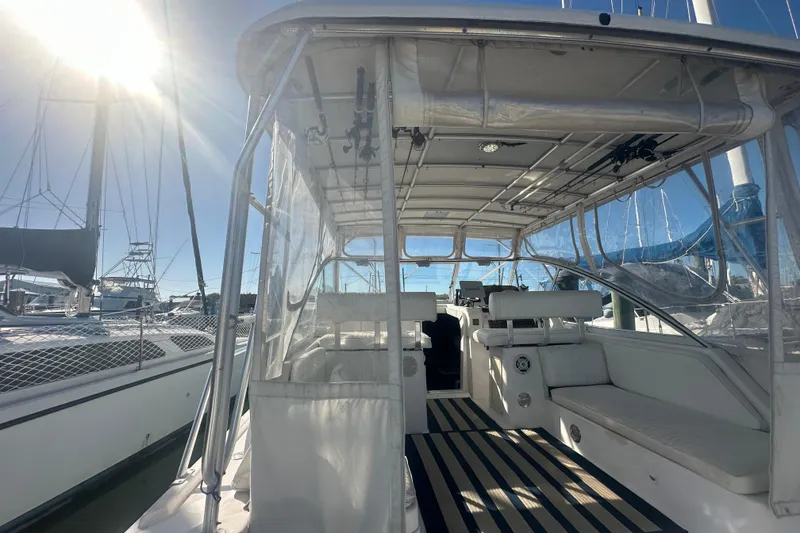 Slide: The Image of 2002 Mainship Pilot 34 boat interior with seating, under sunny sky at marina. - 21