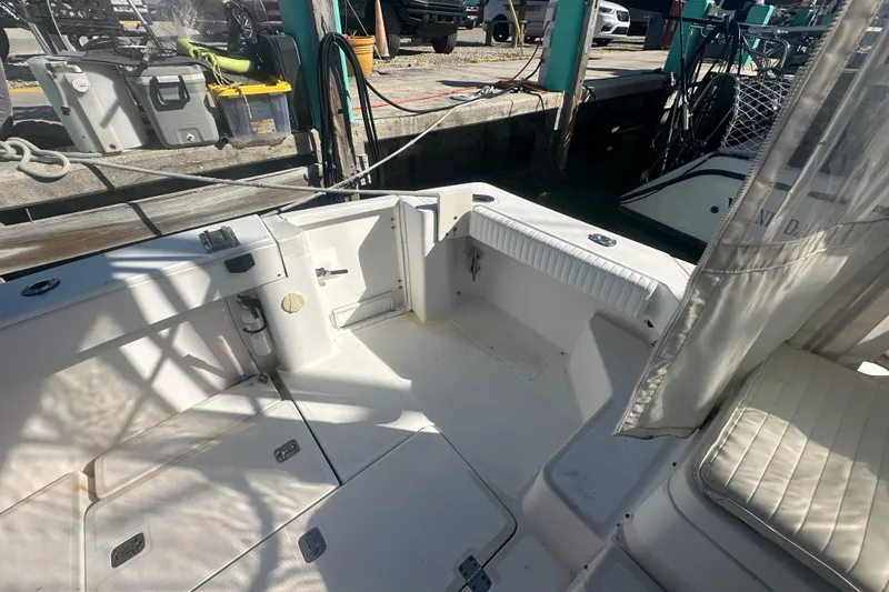 Slide: The Image of 2002 Mainship Pilot 34 boat interior with seating and storage at dockside. - 22