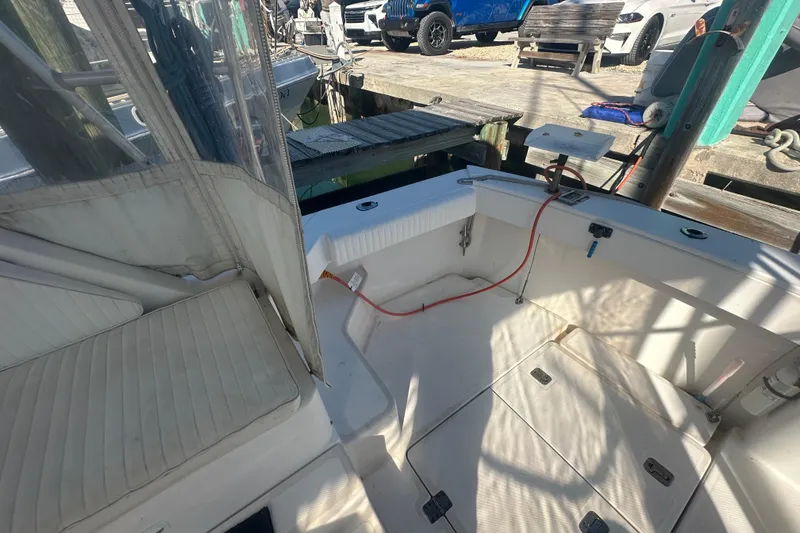 Slide: The Image of 2002 Mainship Pilot 34 boat interior with seating and dock view. - 24