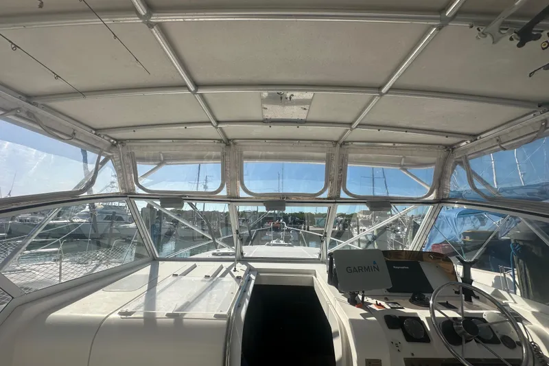 Slide: The Image of 2002 Mainship Pilot 34 boat cockpit with Garmin navigation, docked in a marina. - 25
