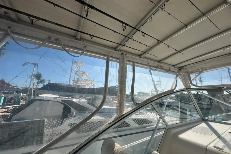 Slide: The Image of 2002 Mainship Pilot 34 interior view with marina backdrop. - 26