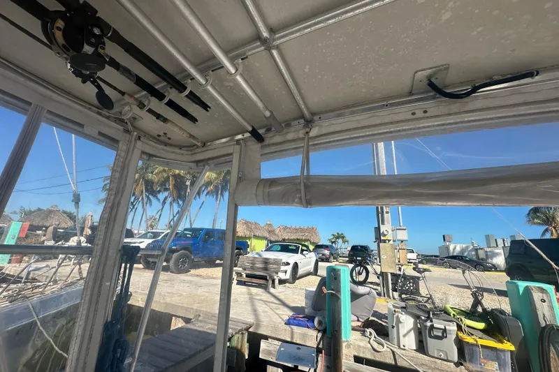 Slide: The Image of Interior view of a 2002 Mainship Pilot 34 boat with fishing gear and dockside scenery. - 29