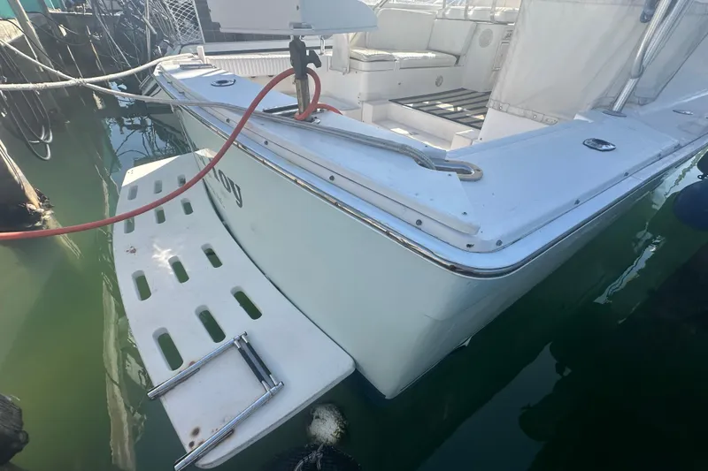 Slide: The Image of 2002 Mainship Pilot 34 boat with swim platform and ladder in marina. - 3