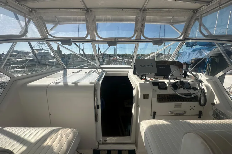 Slide: The Image of 2002 Mainship Pilot 34 helm with Garmin navigation, docked in a marina. - 31