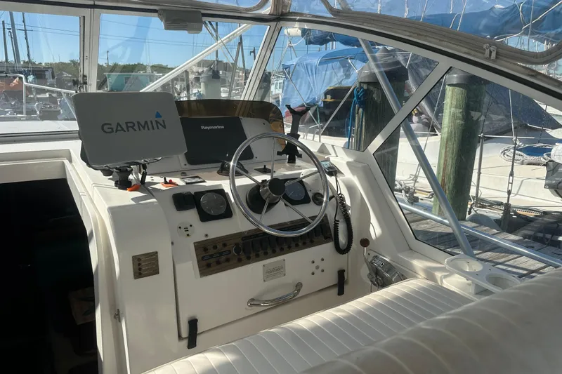 Slide: The Image of 2002 Mainship Pilot 34 helm with Garmin navigation system and steering wheel. - 32