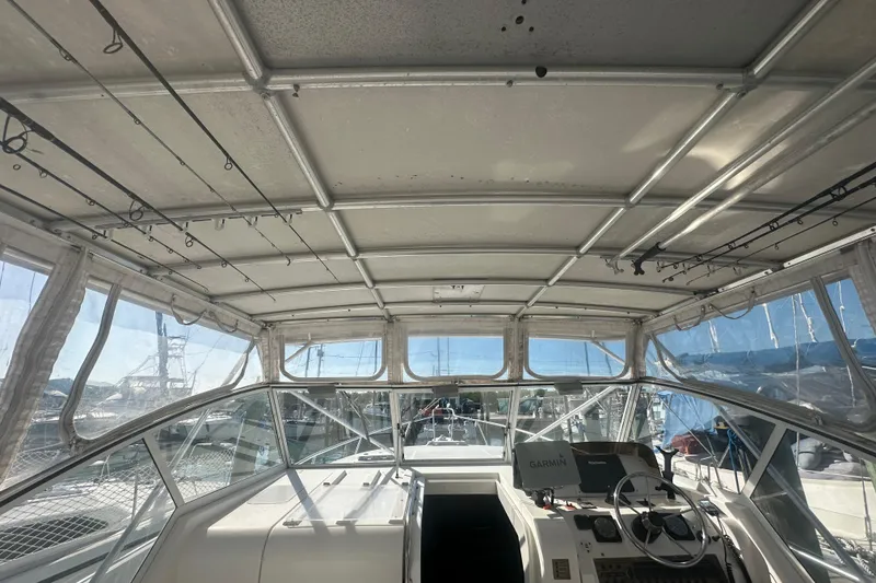 Slide: The Image of 2002 Mainship Pilot 34 boat cockpit with covered helm and navigation equipment. - 33