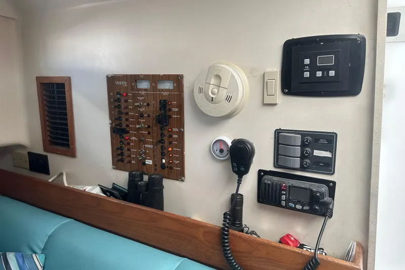 Slide: The Image of 2002 Mainship Pilot 34 interior control panel with communication equipment and safety devices. - 40