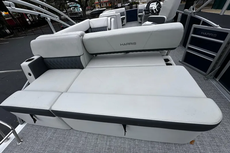 Slide: The Image of 2025 Harris Sunliner 230 boat interior with spacious seating and modern design. - 10