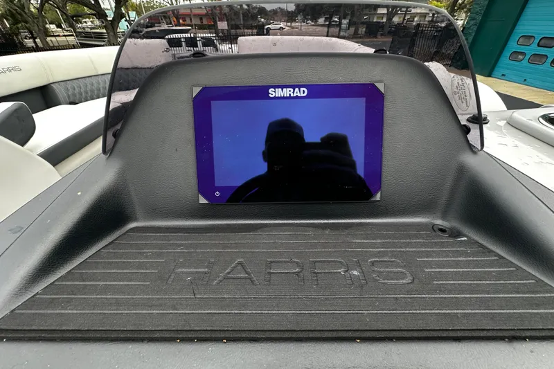 Slide: The Image of Dashboard of 2025 Harris Sunliner 230 with Simrad display screen. - 5