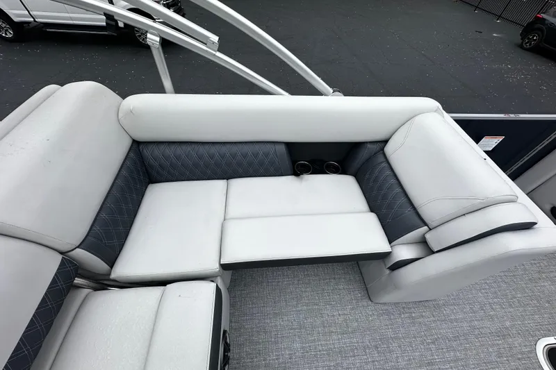 Slide: The Image of 2025 Harris Sunliner 230 boat interior with plush seating and cup holders. - 8