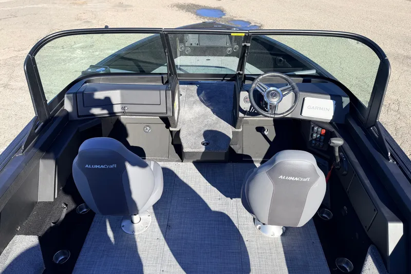 Slide: The Image of 2025 Alumacraft Competitor 185X Sport boat interior with Garmin navigation system and dual seating. - 18